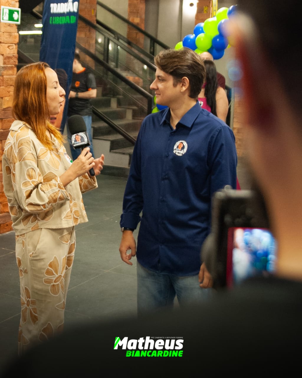 Matheus Biancardine conversando com uma repórter na chegada ao evento